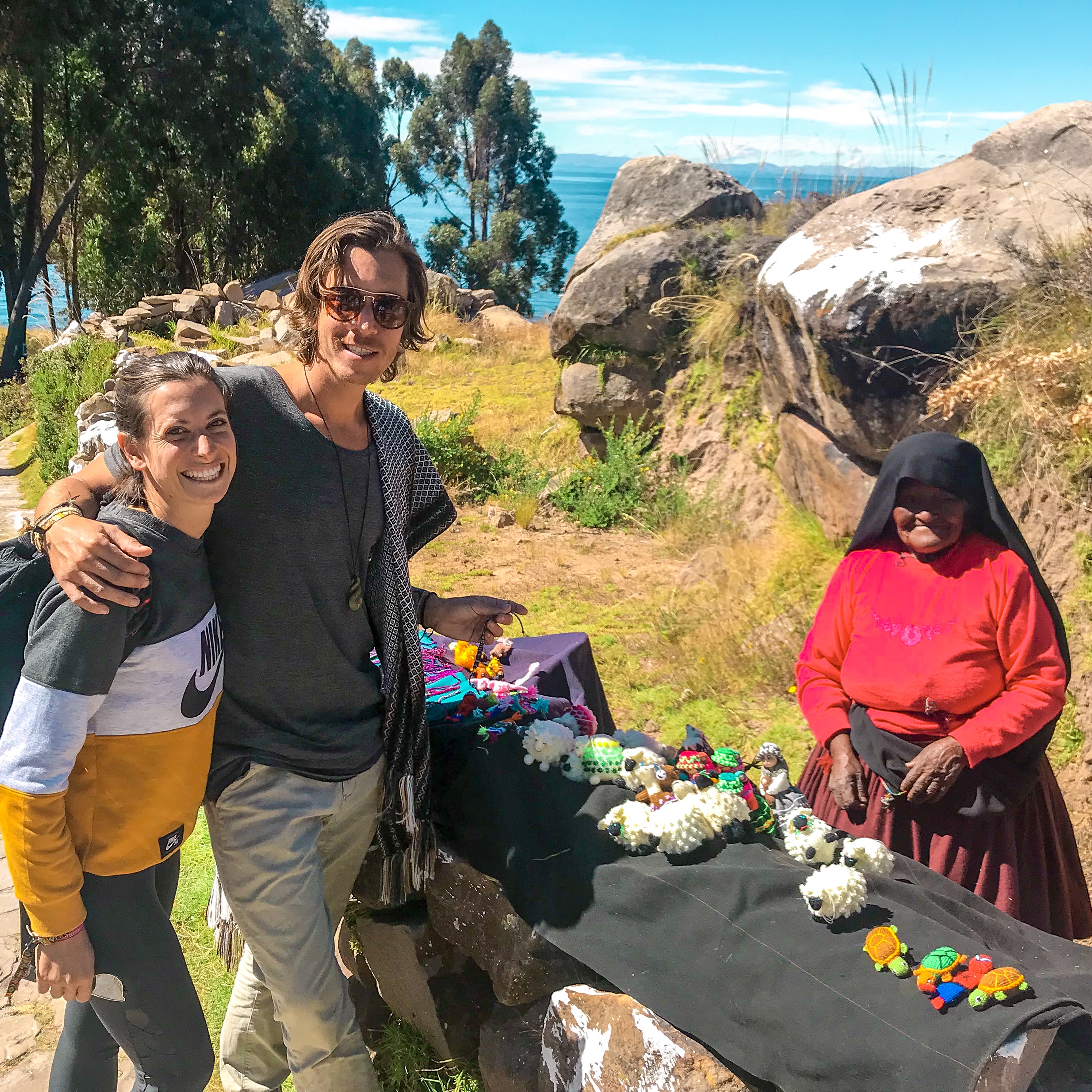 Taquileños woman on Taquile Island, Lake Titicaca Peru, selling her artisan goods. Peruvian culture preservation.
